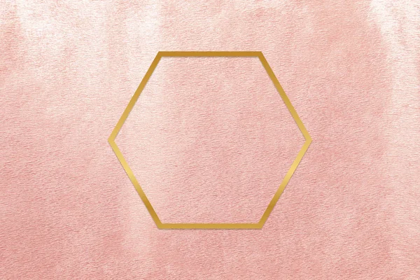 ローズゴールドの背景にゴールドの六角形のフレーム — ストック写真