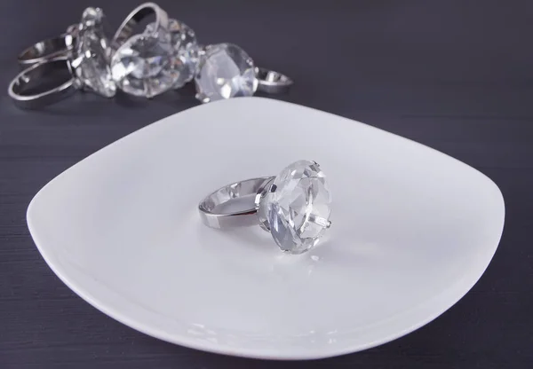 Großer Diamantring Auf Dem Weißen Teller Hintergrund Ein Haufen Ringe — Stockfoto