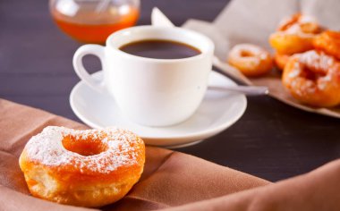 Ahşap karanlık masada kahve ile taze çörek