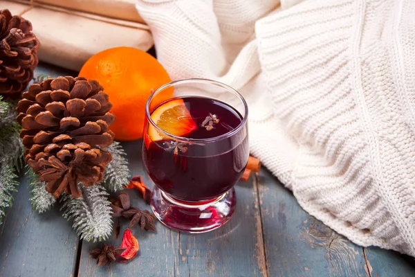 Wineglass with Christmas mulled red wine with spices and fruits on a wooden rustic table. — Stock Photo, Image