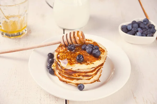 Pancakes with berries and honey on the white background — Stock Photo, Image