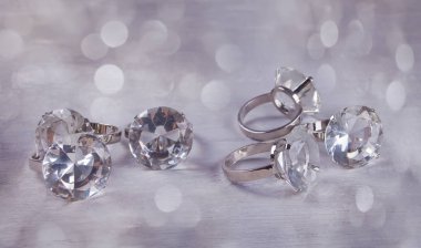 Silver giant wedding rings on a grey background with boke