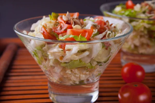 Mixed vegetable salad with tomatoes, onions, cabbage, sprouts of grain in a bowls Stock Photo