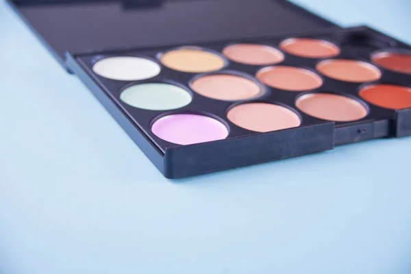 Professional cosmetic. Cream concealer in a palette. Copy space. — Stock Photo, Image