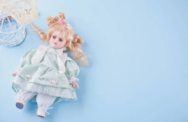 Cute vintage doll on the blue background