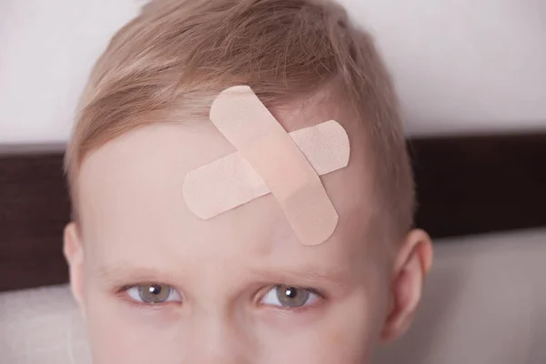 Little boy with plaster on head. Close up. — Stock Photo, Image
