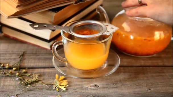 Hand White Woman Pours Sea Buckthorn Tea Transparent Teapot Glass — Stock Video