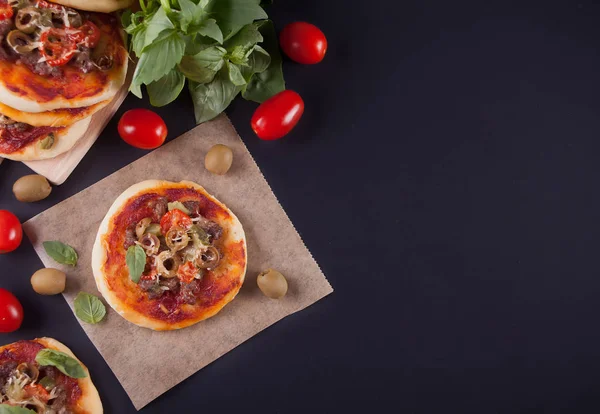 Mini pizza fatta in casa sullo sfondo nero . — Foto Stock