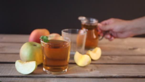 Woman Hand Pouring Glass Drink Green Red Apples Wooden Table — Stock Video