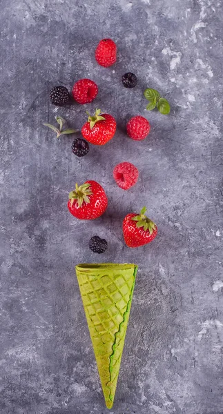 Strawberriess en gofre cono verde sobre un fondo de concrear . — Foto de Stock