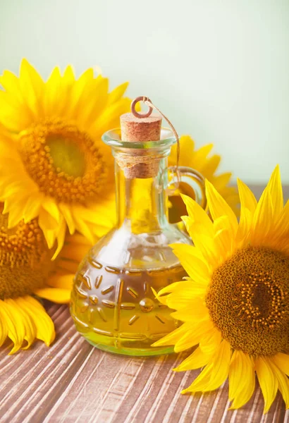 Sunflower oil in a bottle on the wooden table.
