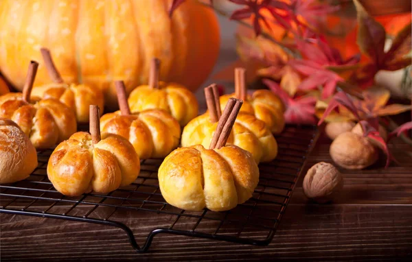 Pumpkin buns on the baking rack. Autumn concept