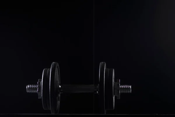 Bodybuilding weights concept on black background. High resolution image concept for bodybuiding or fitness industry.