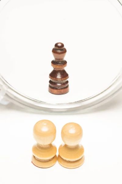 Chess pieces facing a mirror. Business and motivational concepts. High-resolution image.