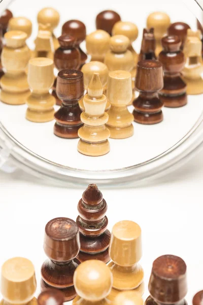 Chess pieces facing a mirror. Business and motivational concepts. High-resolution image.