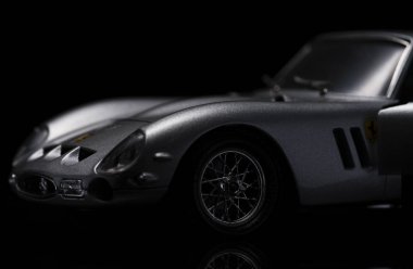 Silver Ferrari 250 GTO on black background. High resolution image for automotive industry. clipart
