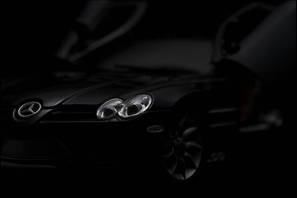 Black SLR McLaren on black background. High resolution image for automotive industry.