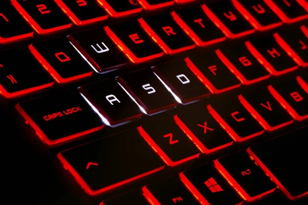 Red Backlit Keyboard Black Background High Resolution Image Gaming Industry Stock Photo