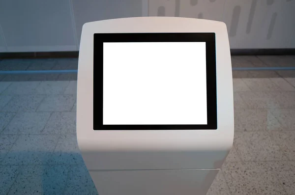 Mockup template/background texture of a blank white touch screen kiosk machine with the background of modern indoor interiors.