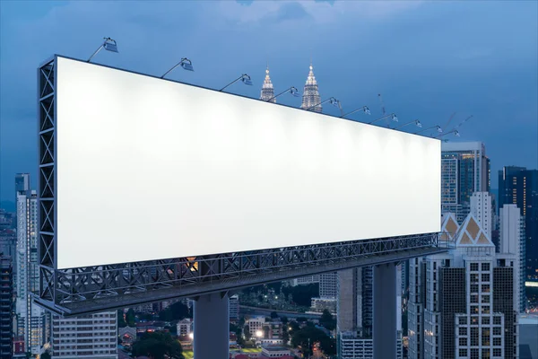 Blank white road billboard with KL cityscape background at night time. Street advertising poster, mock up, 3D rendering. Side view. The concept of marketing communication to promote or sell idea. — Stock Photo, Image