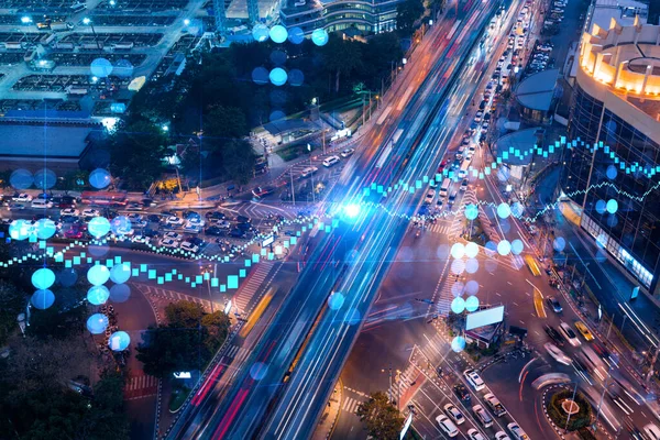 Stock image FOREX and stock market chart hologram on aerial view of road, busy urban traffic highway at night. Junction network of transportation infrastructure. The concept of international trading.