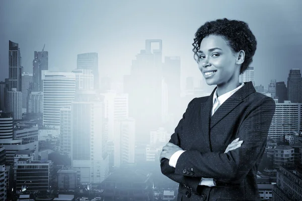 Smiling black African American business woman in suit in crossed arms pose. Bangkok cityscape. The concept of woman in business. Investment fund. Double exposure.