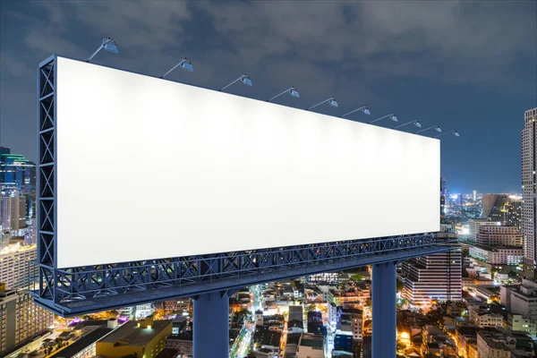 夜のバンコクの街並みを背景にした空白の白い道路看板。ストリート広告ポスター、モックアップ、 3Dレンダリング。サイドビュー。アイデアを販売するためのマーケティングコミュニケーションの概念. — ストック写真