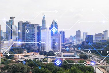 Kuala Lumpur 'un Panorama şehri manzarası üzerinde teknoloji hologramı. KL, Asya 'nın Malezya' daki en büyük teknoloji merkezidir. Kodlama ve yüksek teknoloji geliştirme kavramı. Çift pozlama.