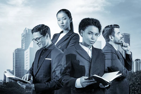 Группа из четырех коллег по бизнесу в костюмах, работающих над проектом вместе, чтобы получить новые карьерные возможности. Концепция многонациональной корпоративной команды в Бангкоке. Двойное воздействие. — стоковое фото