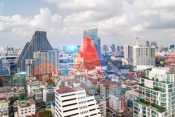 Forex and stock market chart hologram over panorama city view of Bangkok, the financial center in Asia. The concept of international trading. Double exposure.