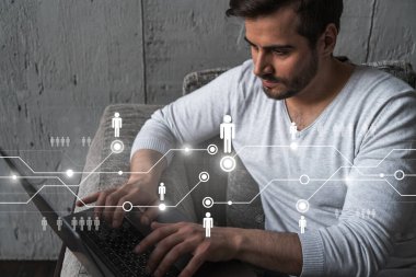 Yeni bir ağ geliştirmek için dizüstü bilgisayar kullanan ciddi bir Kafkasyalı yönetici. Çifte maruziyet. Sosyal medya hologramı.