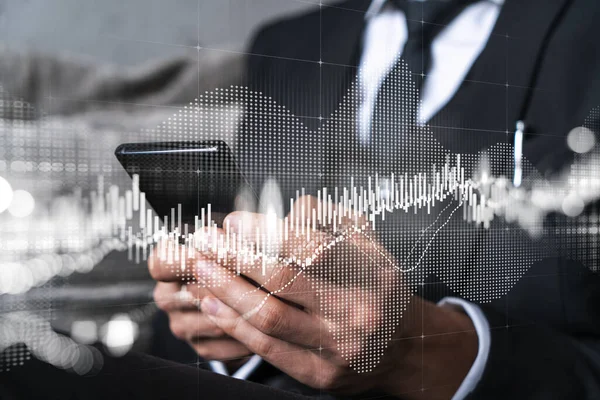 Businessman trading stocks using on-line app on phone. Financial graph hologram.