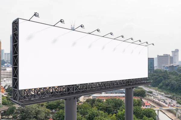 Blank white road billboard with KL cityscape background at day time. Street advertising poster, mock up, 3D rendering. Side view. The concept of marketing communication to promote or sell idea.