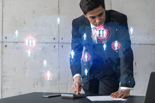 Businessman in office signs contract and world map hologram. Double exposure. Formal wear. International business connection.