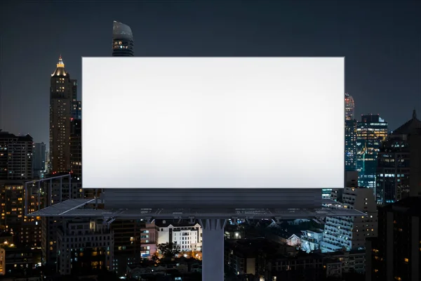 Blank white road billboard with Bangkok cityscape background at night time. Street advertising poster, mock up, 3D rendering. Front view. The concept of marketing communication to promote idea. — Stock Photo, Image