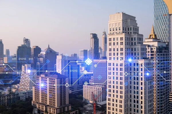 Glowing hologram of technological process, aerial panoramic cityscape of Bangkok at sunset. The largest innovative hub of tech services in Asia. Multi exposure.