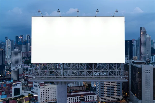 Blank white road billboard with KL cityscape background at night time. Street advertising poster, mock up, 3D rendering. Front view. The concept of marketing communication to promote or sell idea. — Stock Photo, Image