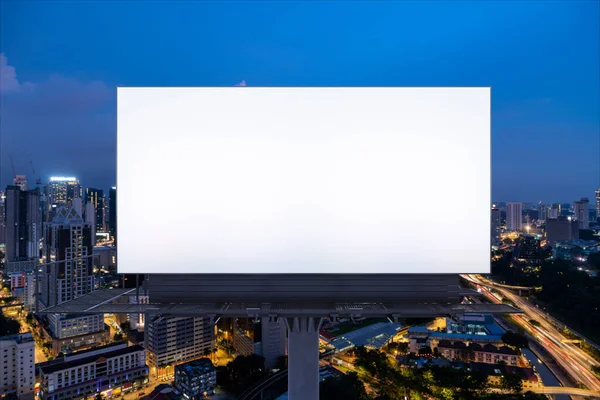 Blank white road billboard with KL cityscape background at night time. Street advertising poster, mock up, 3D rendering. Front view. The concept of marketing communication to promote or sell idea. — Stock Photo, Image