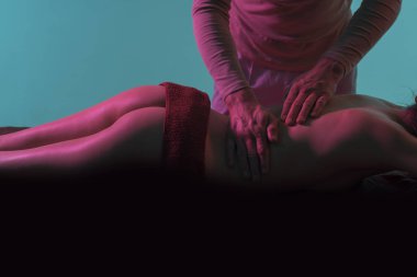 Sexy massage. Erotic massage. Husband strokes back of wife, naked buttocks in dark. Spa, massage room. Relax and therapeutic massage. Femininity, contact body. Healthy back. Young sensual girl ass