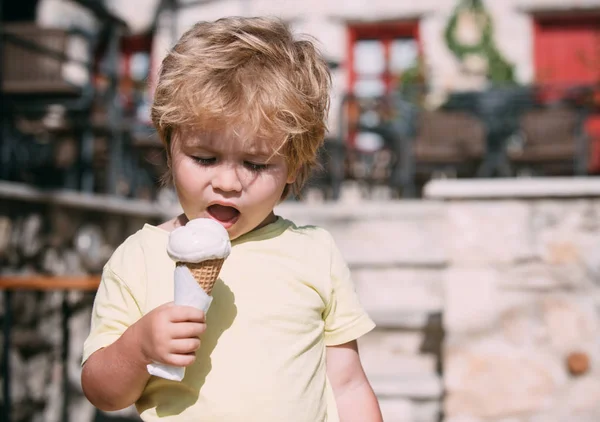 手でアイス クリームのかわいい男の子 金髪の少年は 白アイス クリーム コーンを食べるします 暑い夏 甘いアイスクリームのための時間 夏の時間は 子供と歩きます — ストック写真