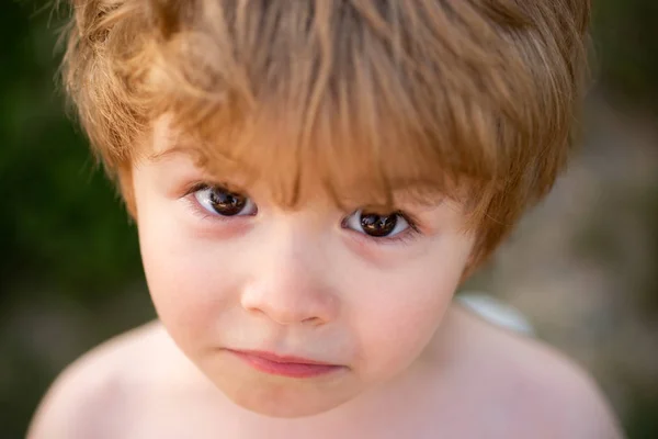 Sad upset boy. Frustrated child. Child sadness. Beautiful baby face with big eyes. Smart boy looking at camera. White boy with brown eyes close up. Frustration. — Stock Fotó