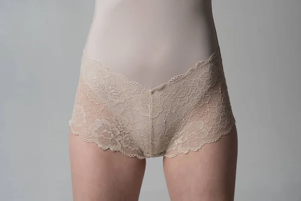 Sanitary napkin for women. Period. Slim woman dressed in white panties close-up. Gynecology, menstruation, the concept of genital health. Hygiene.