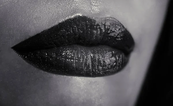 Close up of young female lips on black background. Skin care for woman. Professional male up. Trendy black lips. Expression emotions by lips. Calm closed mouth of young female. — Stock Photo, Image