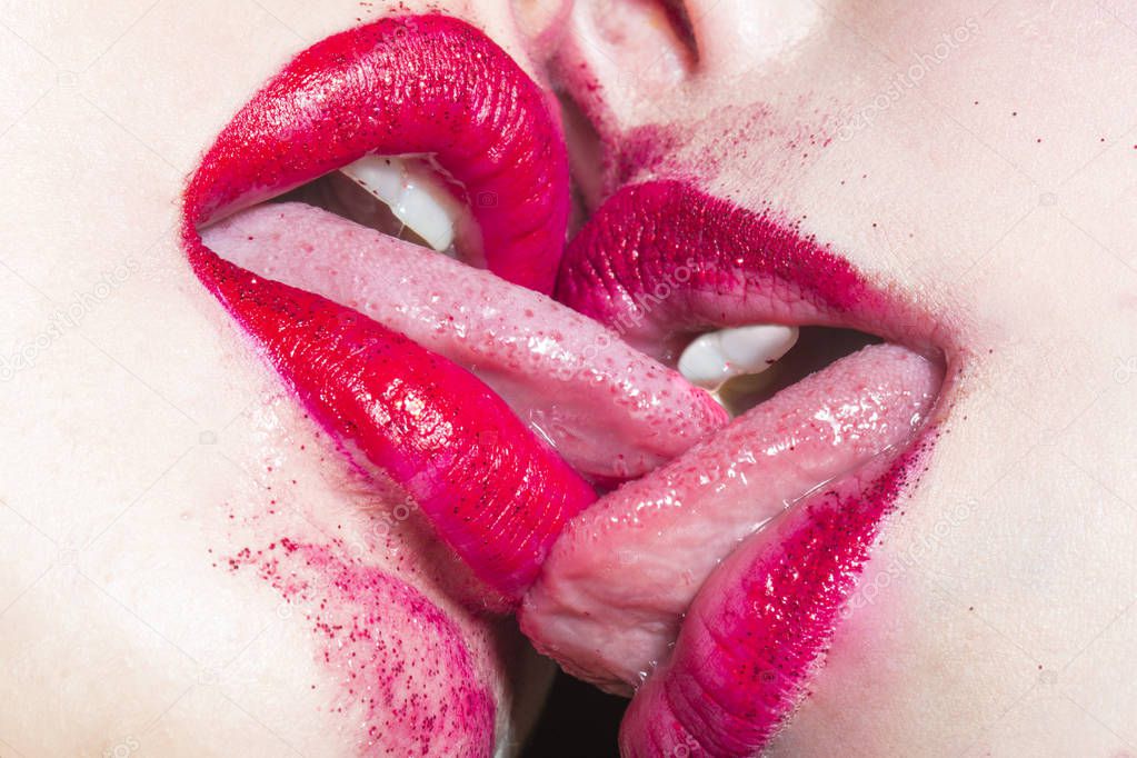 Deep womans kiss. Female love. Lesbians kissing with red lipstick. Closeup of pair women mouths kissing. Two beautiful lesbian girls being intimate. Cosmetics for women. Delicious Erotic Lipstick