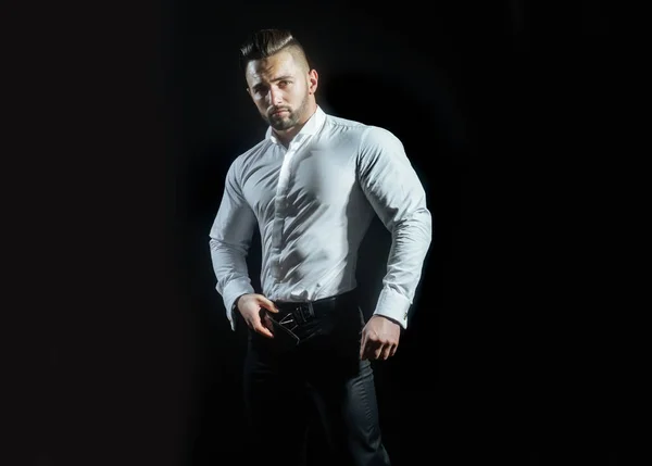 Portrait of successful attractive man in work uniform on black background. Stylish clothes for men at work, office style. Groom before his wedding ceremony. Mens style and fashion.