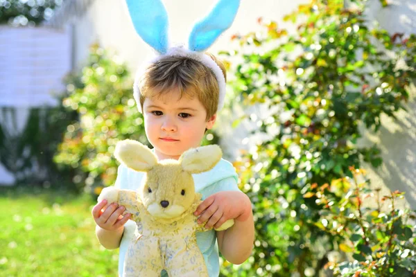 Cute little child wearing bunny ears on Easter day.