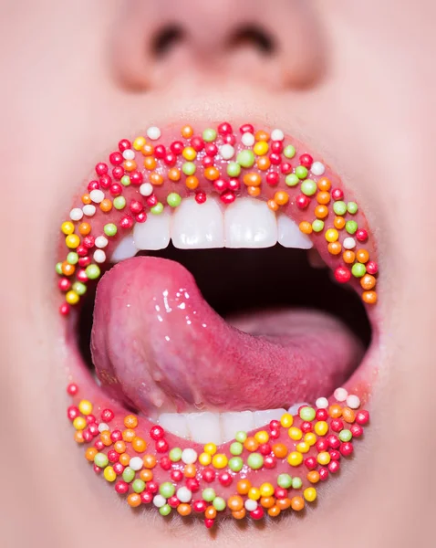 Calories. Sweet mouth and tongue. Candies. Sweet delicious kiss. Sweets concept. Seductive sensual girl. Female mouth closeup. White teeth and sexy tongue. Diet. Low carbon diet. — Stock Photo, Image