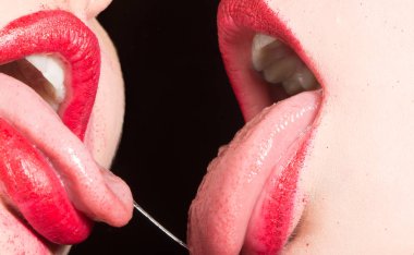 Lezbiyen öpücüğü. Kadınlar arasındaki tutku. Kırmızı ruj ile dişi dudaklar. Yakın ilişkiler. Homoseksüel seks. Gurur. Aynı seks evliliği. Seksi öpücük. Tükürük ile ağzına baştan çıkarıcı kadınsı dil. Fransız öpücüğü