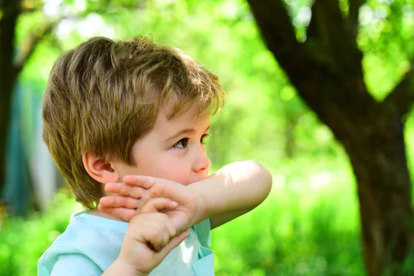 Insect bite, mosquito wound. Remedy for mosquitoes, saliva from bite. Serious look from young boy. Lonely child in park. Sad kid during outdoor walk in forest. Scincere emotions from young male