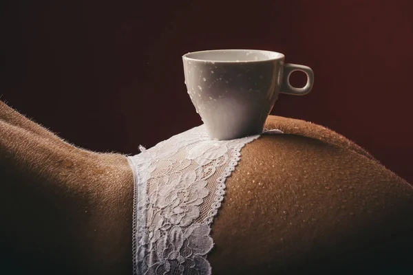 A young girl drinks coffee. 